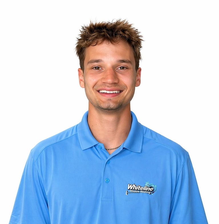 Man wearing blue Whiteline polo shirt smiling at camera against white background